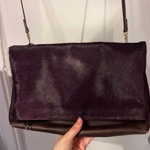 Eggplant pony hair pouch. Multiple inside pockets. Lightly worn.
